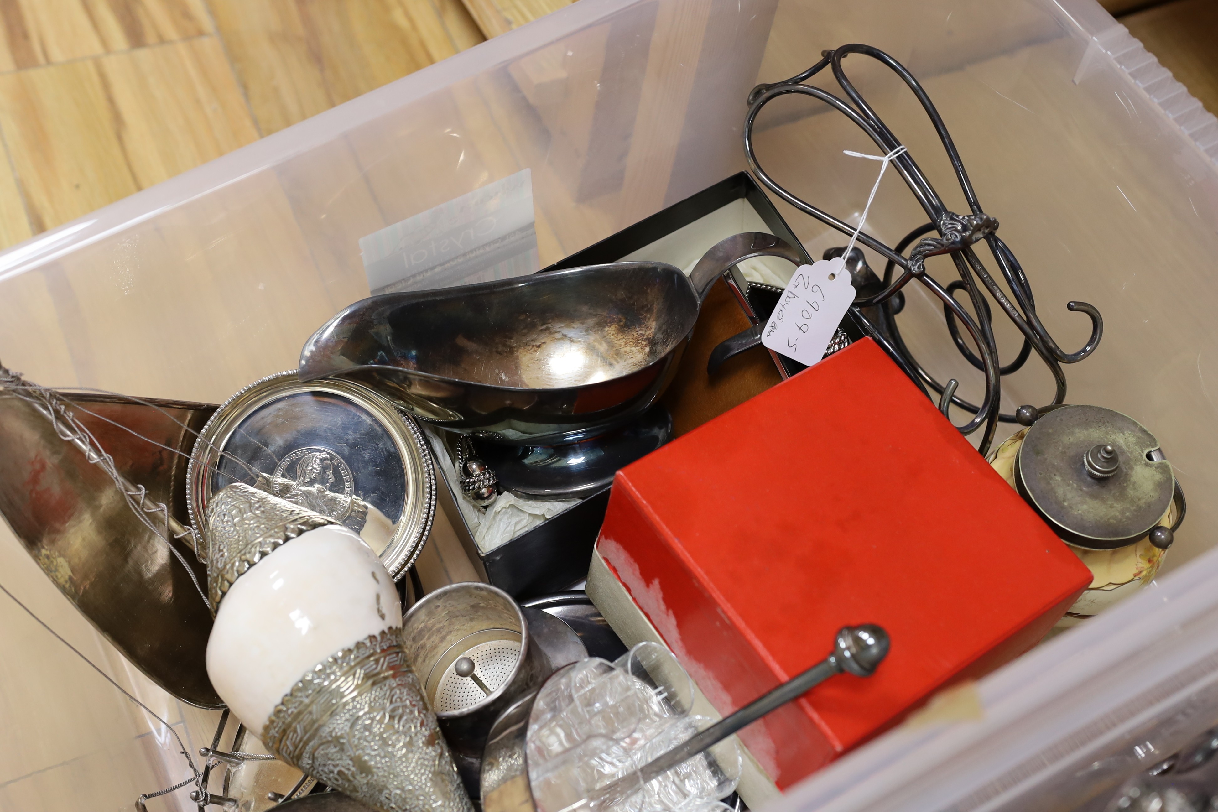 A large quantity of assorted plate wares including an Elkington & Co bottle pourer, a model yacht, two hip flasks, flatware, chambersticks, etc.